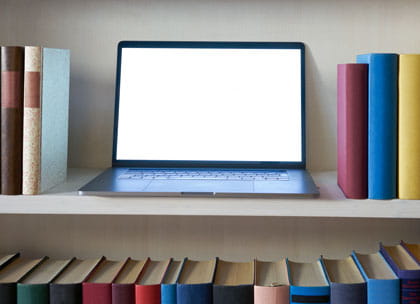 Laptop on bookshelves